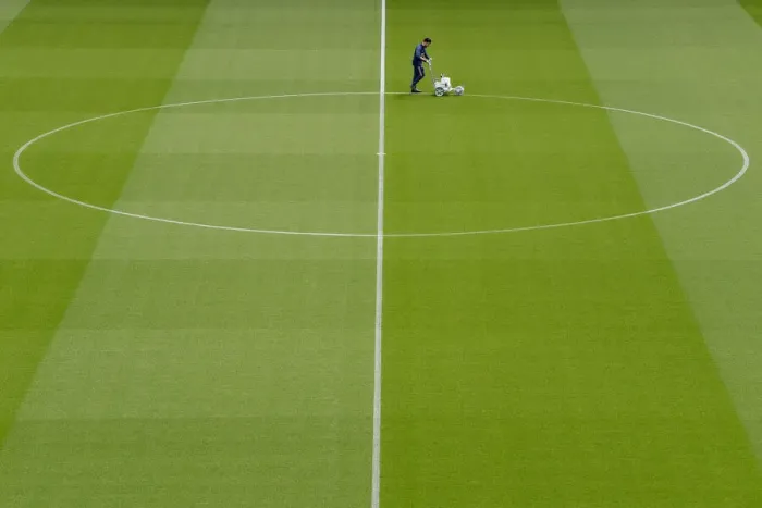 Framed Print : Arsenal's Groundsman Prepares Emirates Turf for Arsenal vs Brighton & Hove Albion