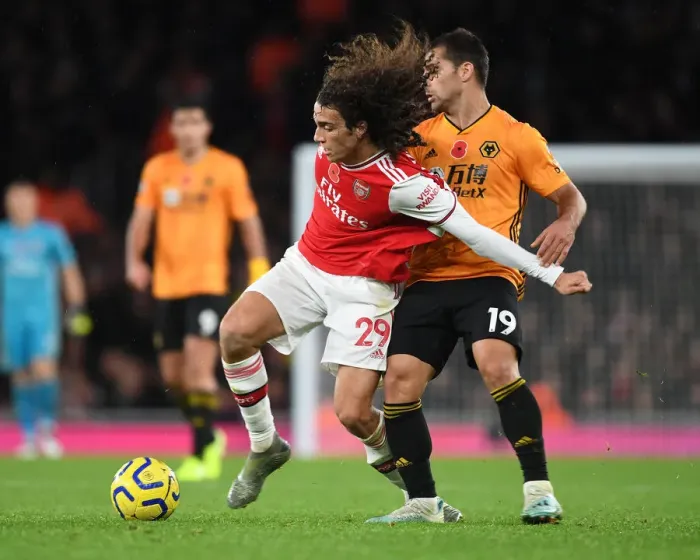 Framed Print : Arsenal's Guendouzi Outmaneuvers Wolves Jonny in Premier League Clash Framed Print : Arsenal's Guendouzi Outmaneuvers Wolves Jonny in Premier League Clash