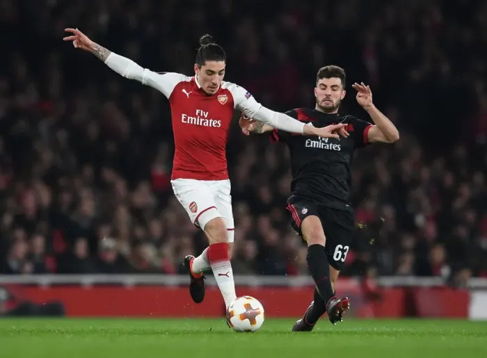 Framed Print : Arsenal's Hector Bellerin Clashes with AC Milan's Patrick Cutrone in Europa League Showdown