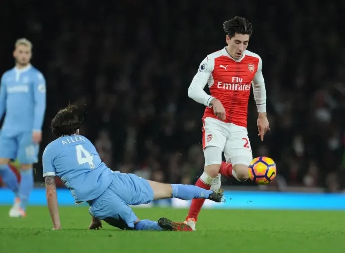Framed Print : Arsenal's Hector Bellerin Faces Off Against Stoke City's Joe Allen in Premier League Clash