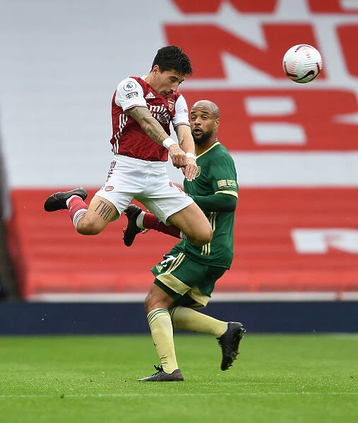 Arsenal's Hector Bellerin Overpowers Sheffield United's McGoldrick in Empty Emirates Stadium