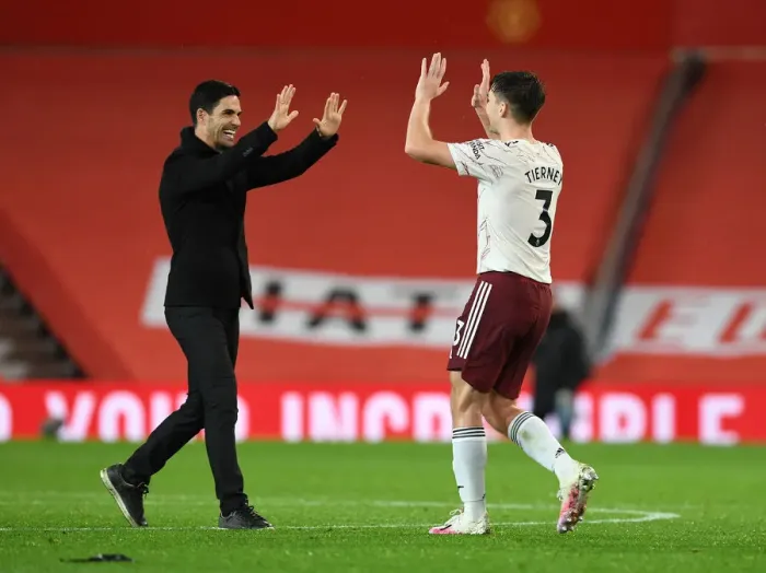 Framed Print : Arsenal's Historic Victory at Old Trafford: Mikel Arteta and Kieran Tierney Celebrate Amidst Empty Stands (Manchester United vs Arsenal, 2020-21)