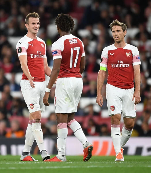 Arsenal's Holding, Iwobi, and Monreal: United in Action during UEFA Europa League Match
