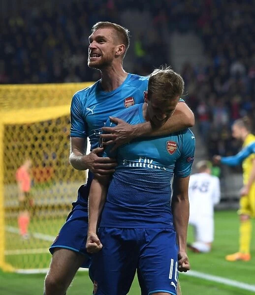 Arsenal's Holding and Mertesacker Celebrate Goals Against FC BATE Borisov in Europa League