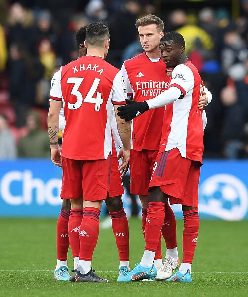 Arsenal's Holding and Pepe Celebrate Victory Over Watford in Premier League
