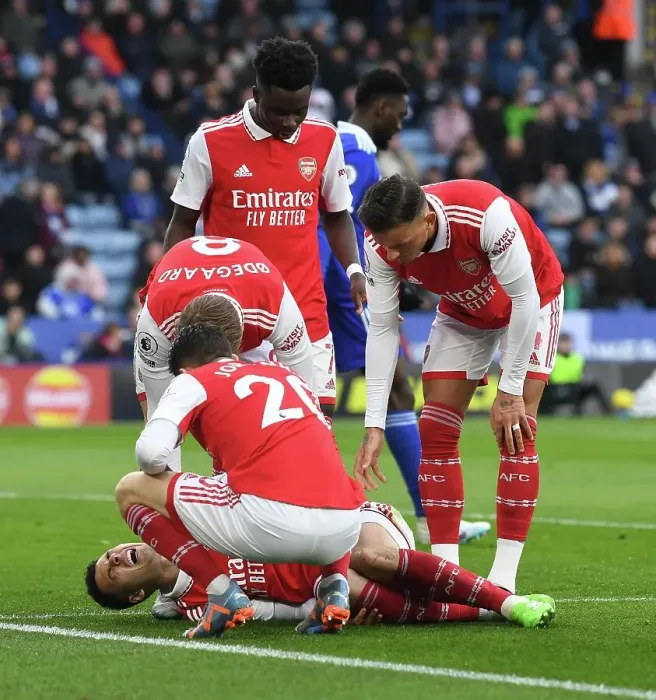 Framed Print : Arsenal's Injured Martinelli and Team Mates Amid Leicester Battle