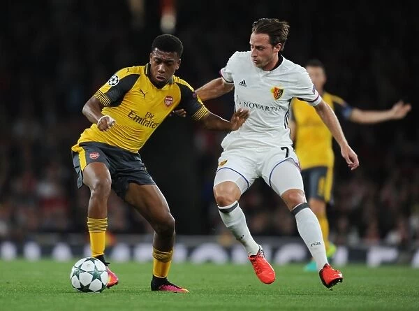 Arsenal's Iwobi Fends Off Basel's Zuffi in Champions League Showdown