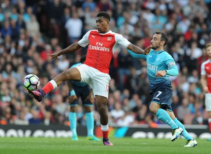 Framed Print : Arsenal's Iwobi Outsmarts Swansea's Britton in Premier League Showdown Framed Print : Arsenal's Iwobi Outsmarts Swansea's Britton in Premier League Showdown
