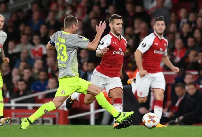 Framed Print : Arsenal's Jack Wilshere Clashes with 1. FC Koeln's Matthias Lehmann in Europa League Showdown