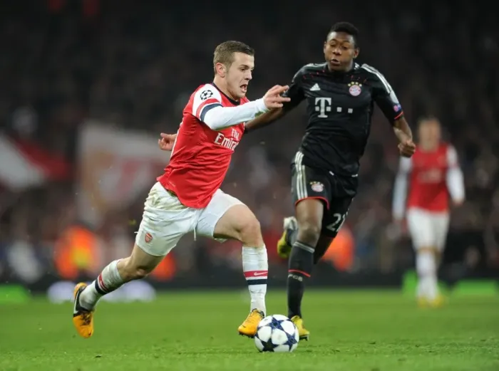 Framed Print : Arsenal's Jack Wilshere Clashes with Bayern Munchen's David Alaba in Champions League Showdown