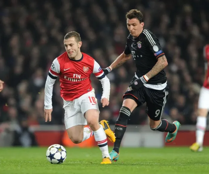 Framed Print : Arsenal's Jack Wilshere Clashes with Bayern's Mario Mandzukic in Champions League Showdown