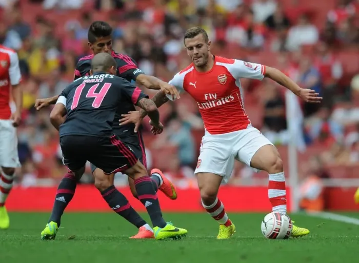 Framed Print : Arsenal's Jack Wilshere Clashes with Benfica's Maxi Pereira in Emirates Cup Showdown