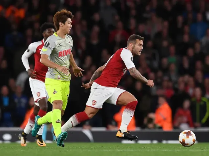Framed Print : Arsenal's Jack Wilshere Clashes with FC Köln's Yuya Osako in Europa League Showdown Framed Print : Arsenal's Jack Wilshere Clashes with FC Köln's Yuya Osako in Europa League Showdown