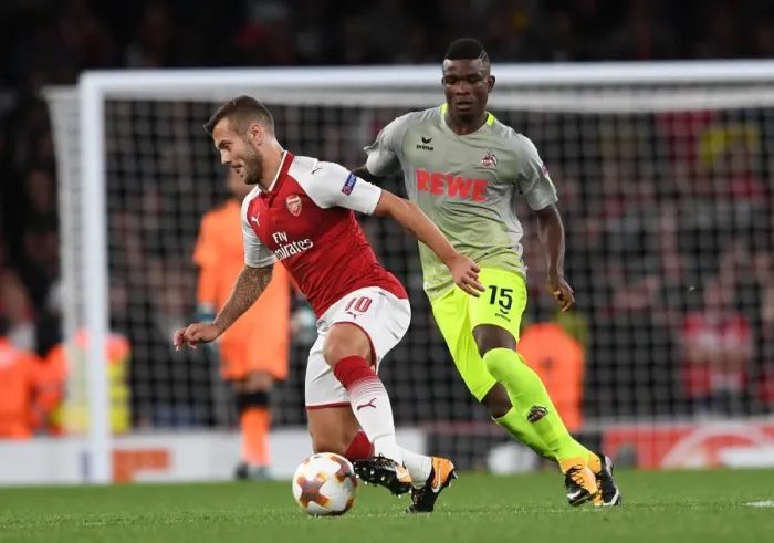 Framed Print : Arsenal's Jack Wilshere Clashes with Jhon Cordoba in Europa League Showdown