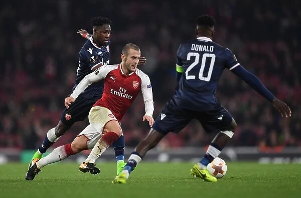 Arsenal's Jack Wilshere Clashes with Red Star's Richmond Boakye and Mitchell Donald during Europa League Match
