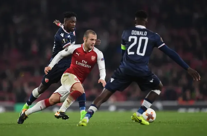 Framed Print : Arsenal's Jack Wilshere Clashes with Red Star's Richmond Boakye and Mitchell Donald during Europa League Match Framed Print : Arsenal's Jack Wilshere Clashes with Red Star's Richmond Boakye and Mitchell Donald during Europa League Match