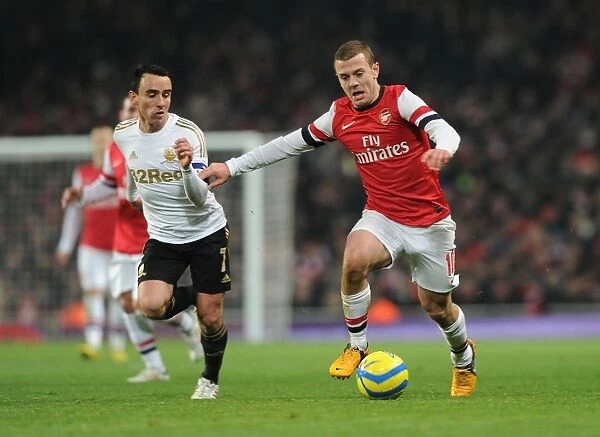 Arsenal's Jack Wilshere Clashes with Swansea's Leon Britton in FA Cup Third Round Replay