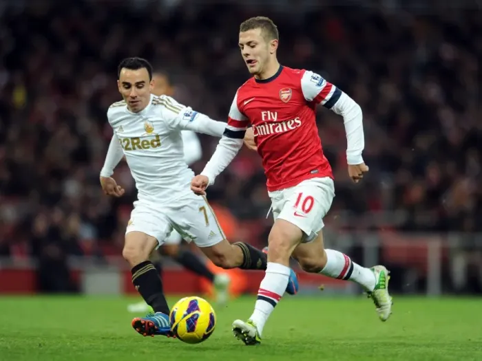 Framed Print : Arsenal's Jack Wilshere Clashes with Swansea's Leon Britton during the 2012-13 Premier League Match