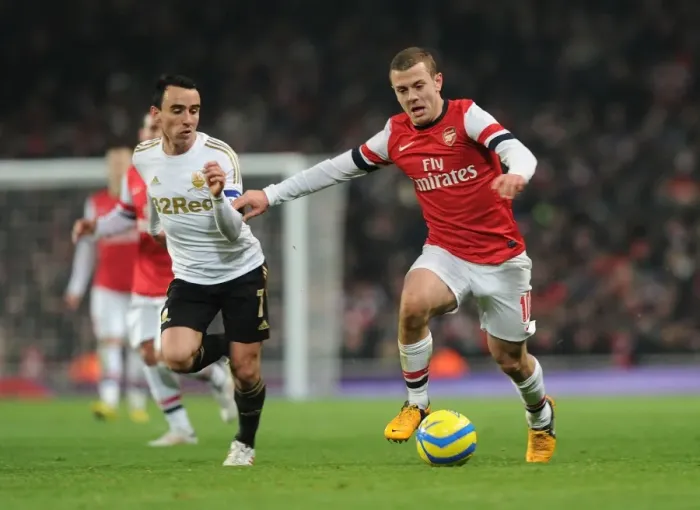 Framed Print : Arsenal's Jack Wilshere Clashes with Swansea's Leon Britton in FA Cup Third Round Replay Framed Print : Arsenal's Jack Wilshere Clashes with Swansea's Leon Britton in FA Cup Third Round Replay