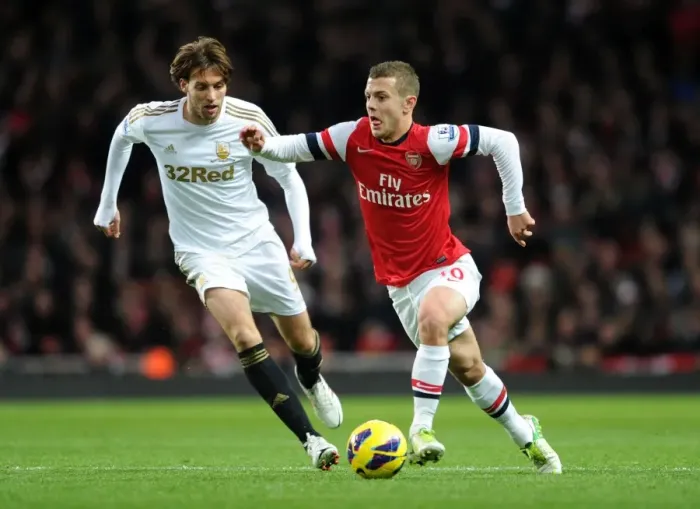 Framed Print : Arsenal's Jack Wilshere Clashes with Swansea's Miguel Michu in Premier League Showdown (2012-13) Framed Print : Arsenal's Jack Wilshere Clashes with Swansea's Miguel Michu in Premier League Showdown (2012-13)
