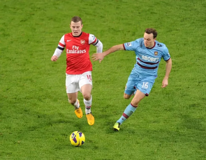Framed Print : Arsenal's Jack Wilshere Clashes with West Ham's Mark Noble in Premier League Showdown Framed Print : Arsenal's Jack Wilshere Clashes with West Ham's Mark Noble in Premier League Showdown