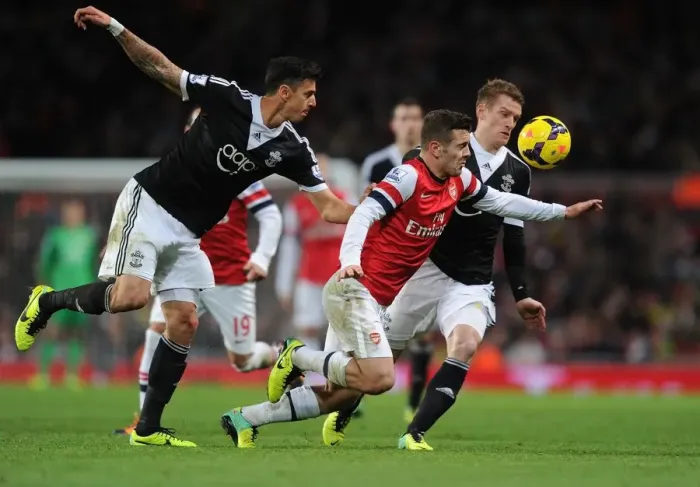 Framed Print : Arsenal's Jack Wilshere Drives Past Southampton's Defense in 2013-14 Premier League Clash