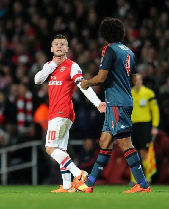 Framed Print : Arsenal's Jack Wilshere Faces Off Against Bayern Munchen's Dante in Champions League Showdown Framed Print : Arsenal's Jack Wilshere Faces Off Against Bayern Munchen's Dante in Champions League Showdown