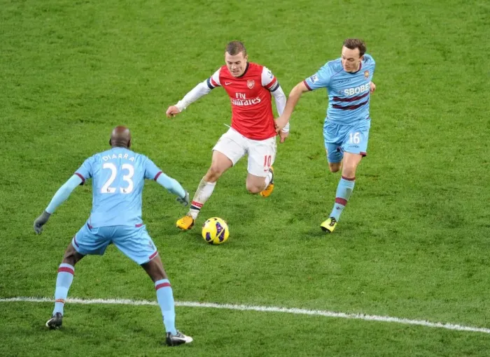 Framed Print : Arsenal's Jack Wilshere Faces Off Against Mark Noble and Alou Diarra of West Ham United Framed Print : Arsenal's Jack Wilshere Faces Off Against Mark Noble and Alou Diarra of West Ham United
