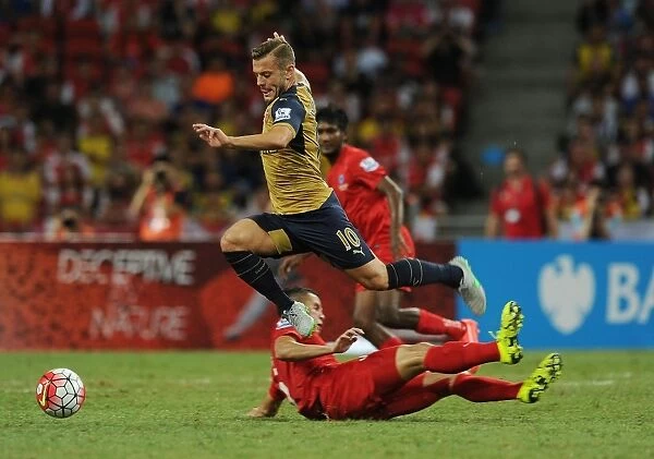 Arsenal's Jack Wilshere Faces Off Against Shahdan Sulaiman of Singapore XI at Barclays Asia Trophy