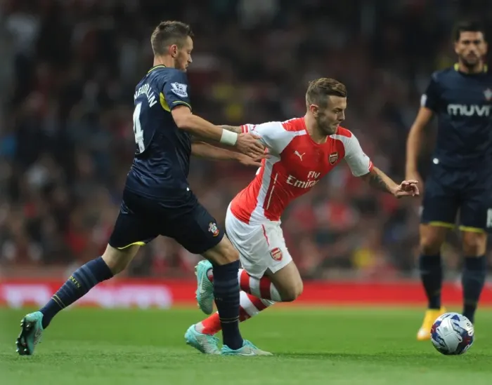 Framed Print : Arsenal's Jack Wilshere Faces Off Against Southampton's Morgan Schneiderlen in League Cup Clash