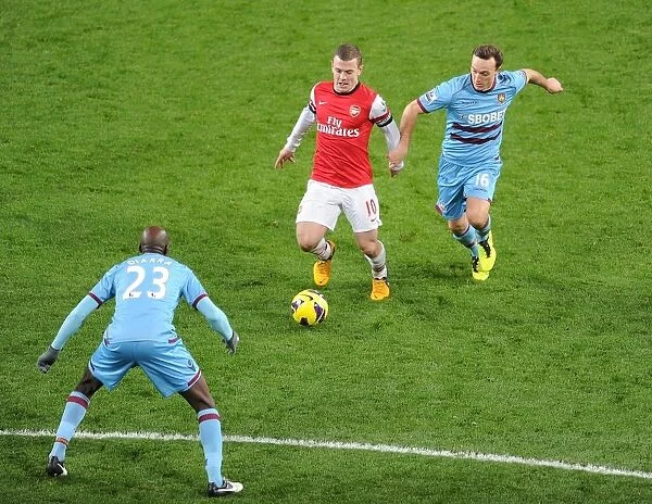 Arsenal's Jack Wilshere Faces Off Against West Ham's Mark Noble and Alou Diarra