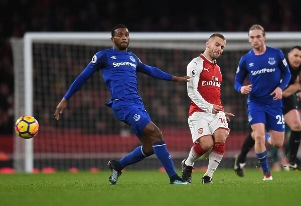 Arsenal's Jack Wilshere Fends Off Everton's Cuco Martina During Premier League Clash