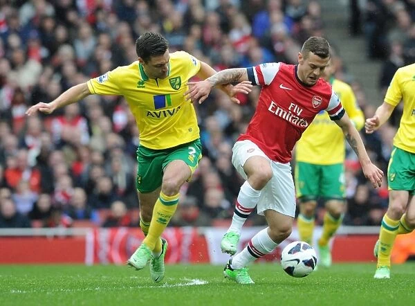 Arsenal's Jack Wilshere Fends Off Norwich's Russell Martin during the 2013 Premier League Clash