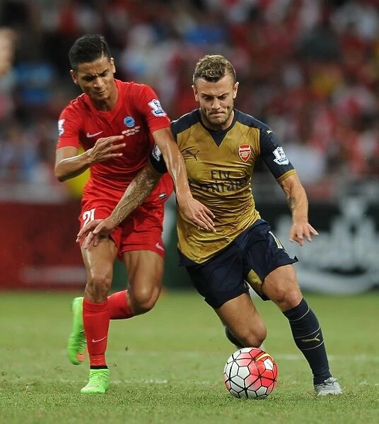 Arsenal's Jack Wilshere Fends Off Singapore XI's Safuwan Baharudin During Barclays Asia Trophy Match