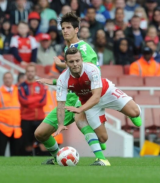 Arsenal's Jack Wilshere Fouls by VfL Wolfsburg's Timm Klose during Emirates Cup 2015 / 16 Match