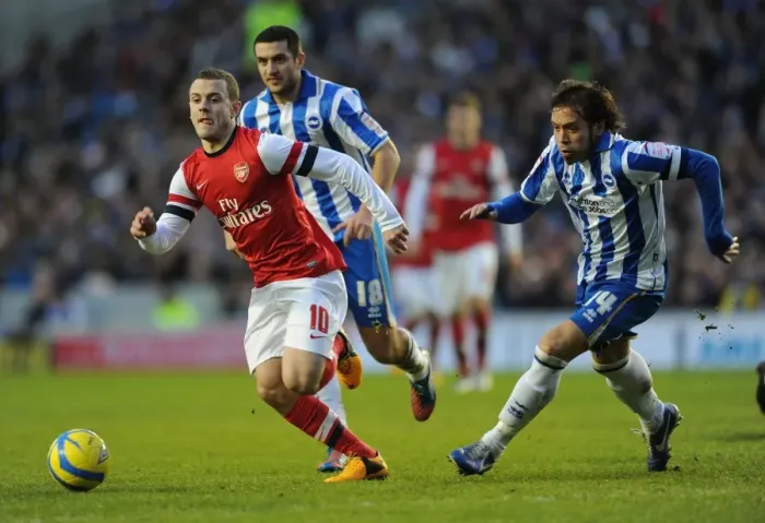 Framed Print : Arsenal's Jack Wilshere Goes Head-to-Head with Brighton's Gary Dicker and Inigo Calderon in FA Cup Showdown