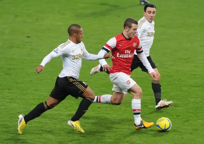 Framed Print : Arsenal's Jack Wilshere Goes Head-to-Head with Swansea's Ashley Richards and Leon Britton in FA Cup Clash Framed Print : Arsenal's Jack Wilshere Goes Head-to-Head with Swansea's Ashley Richards and Leon Britton in FA Cup Clash