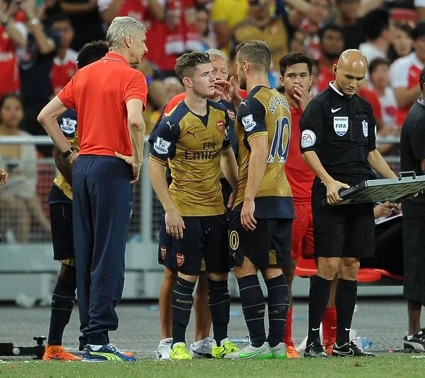 Arsenal's Jack Wilshere Hands Over the Torch to Dan Crowley during Arsenal v Singapore XI Match, 2015