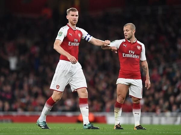 Arsenal's Jack Wilshere and Per Mertesacker in Action against Doncaster Rovers in Carabao Cup