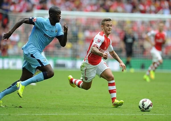 Arsenal's Jack Wilshere Outmaneuvers Manchester City's Yaya Toure in FA Community Shield Clash