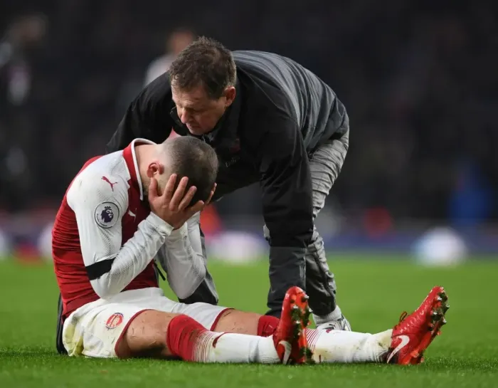 Framed Print : Arsenal's Jack Wilshere Receives Medical Attention from Physio Colin Lewin during Premier League Match Framed Print : Arsenal's Jack Wilshere Receives Medical Attention from Physio Colin Lewin during Premier League Match