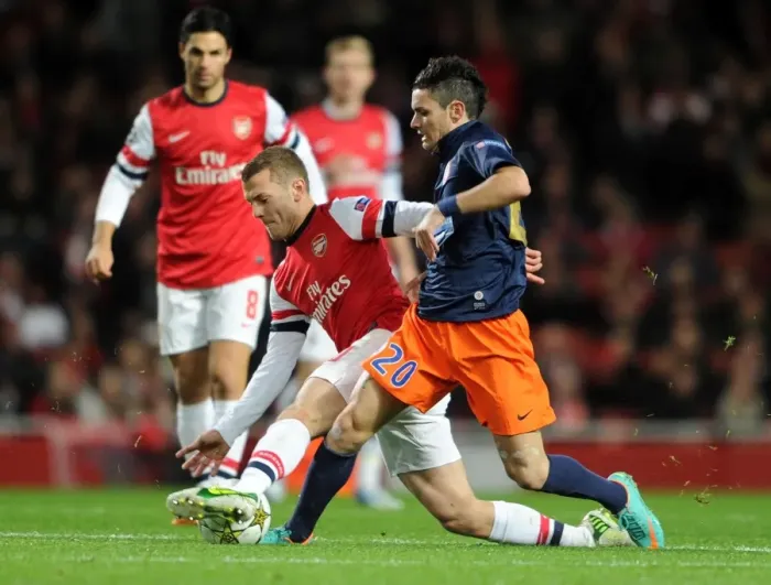 Framed Print : Arsenal's Jack Wilshere Tackles Montpellier's Remy Cabella in Champions League Clash Framed Print : Arsenal's Jack Wilshere Tackles Montpellier's Remy Cabella in Champions League Clash