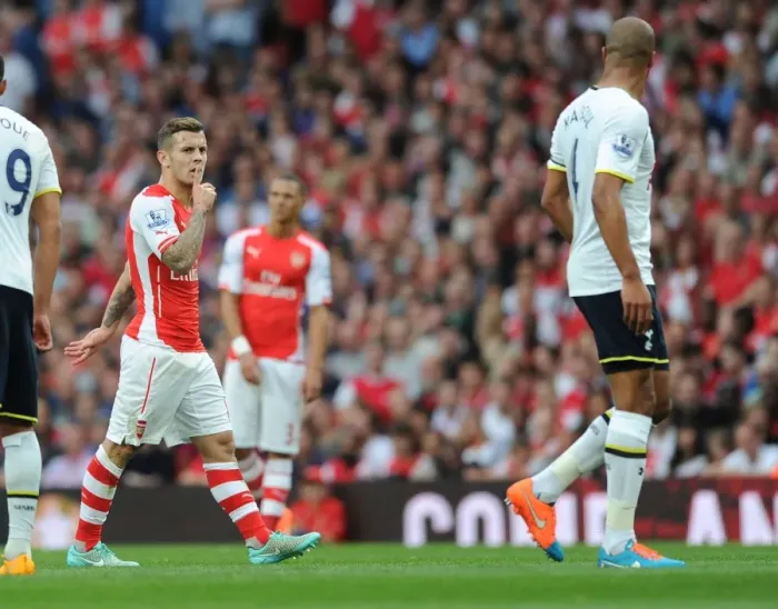 Framed Print : Arsenal's Jack Wilshere and Tottenham's Younes Kaboul Lock Eyes During Intense Rivalry