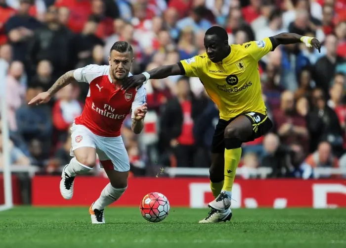 Framed Print : Arsenal's Jack Wilshere vs. Aly Cissokho: A Premier League Battle at Emirates Stadium