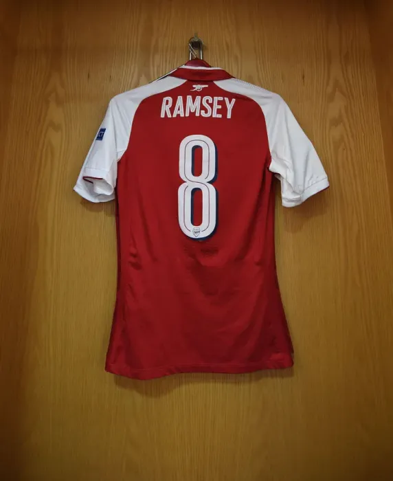 Framed Print : Arsenal's Empty Jersey: Aaron Ramsey's Absence in UEFA Europa League Semi-Final vs Atletico Madrid