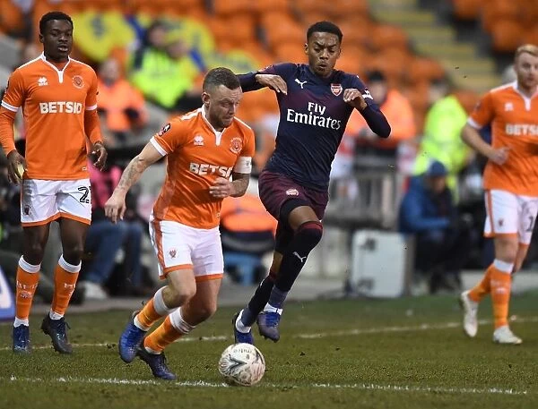 Arsenal's Joe Willock Clashes with Blackpool's Jay Spearing in FA Cup Third Round