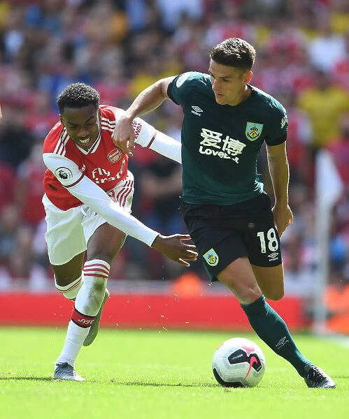 Arsenal's Joe Willock Clashes with Burnley's Ashley Westwood in Premier League Showdown
