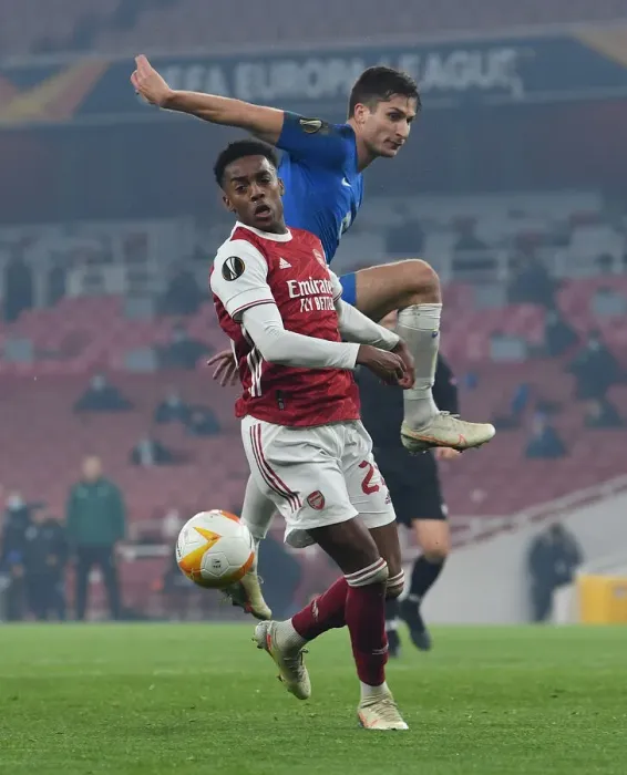 Framed Print : Arsenal's Joe Willock Faces Off Against Kristoffer Haugen in Europa League Clash Framed Print : Arsenal's Joe Willock Faces Off Against Kristoffer Haugen in Europa League Clash