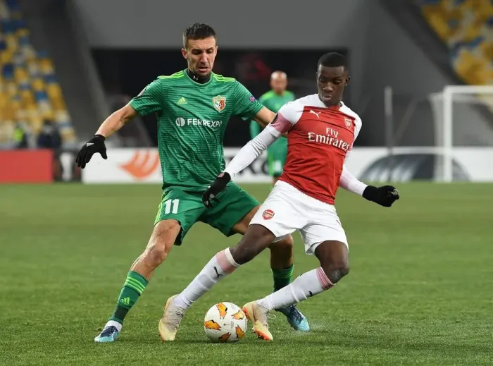 Framed Print : Arsenal's Joe Willock Faces Off Against Vyacheslav Sharpar in Europa League Clash Framed Print : Arsenal's Joe Willock Faces Off Against Vyacheslav Sharpar in Europa League Clash