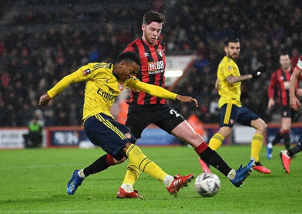 Arsenal's Joe Willock Faces Pressure from Bournemouth's Jack Simpson in FA Cup Clash
